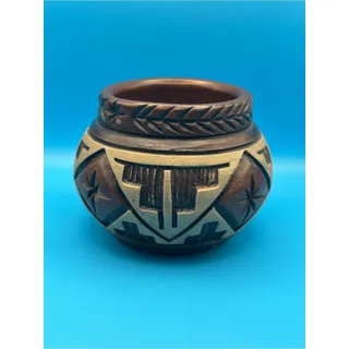 Photo of Handcrafted Pottery with Intricate Carved Geometric Designs