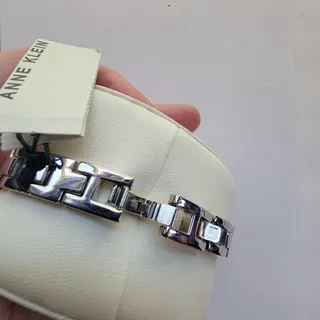 Photo of Anne Klein Womens Watch 32mm Silver Dial Silver Case Gold Bezel Bangle Quartz