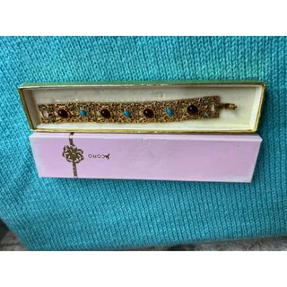 Photo of vintage goldtone filigree bracelet with maroon and blue gems