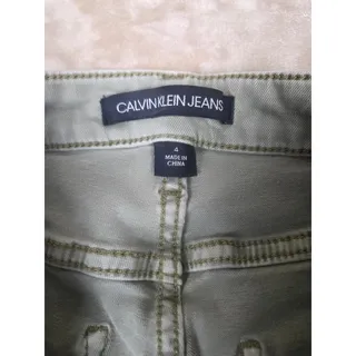 Photo of Calvin Klein women's straight-leg cropped jeans feature a sage green/light mint