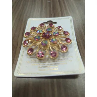 Photo of Gold and purple pin/brooch with multicolored rhinestones